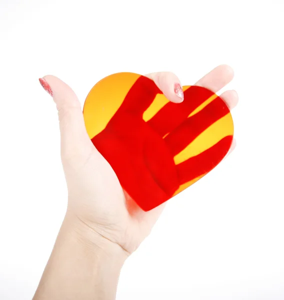Corazón rojo transparente en la mano — Foto de Stock