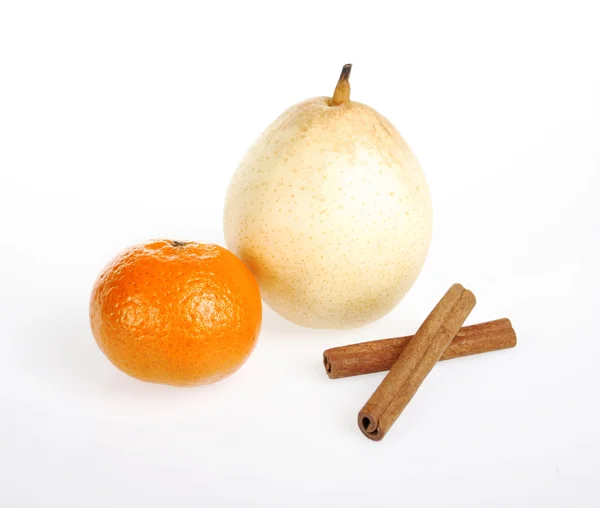 Tangerine, pear and cinnamon sticks — Stock Photo, Image