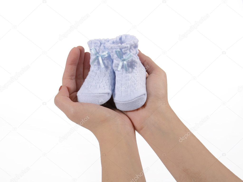 Blue baby booties in hands