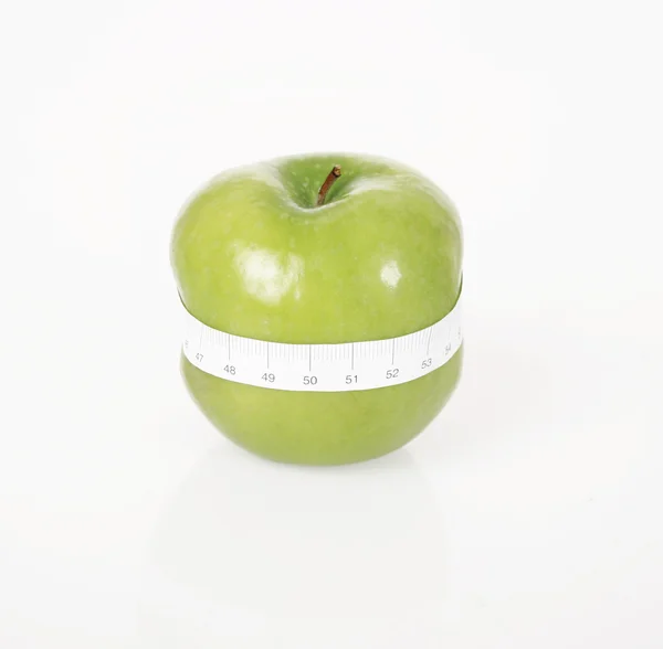 Green apple with measure tape — Stock Photo, Image