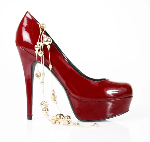 Red glitter shoe and gold necklace — Stock Photo, Image