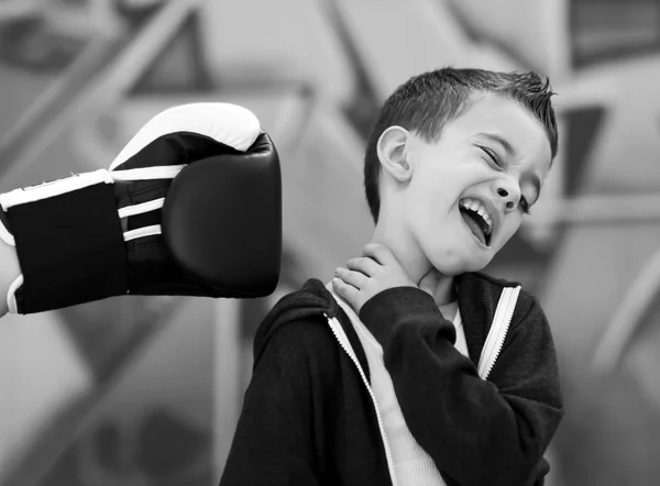 stock image Young boy bing punched in face with boxng glove