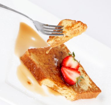 French toast with drip of syrup and strawberries on white background clipart