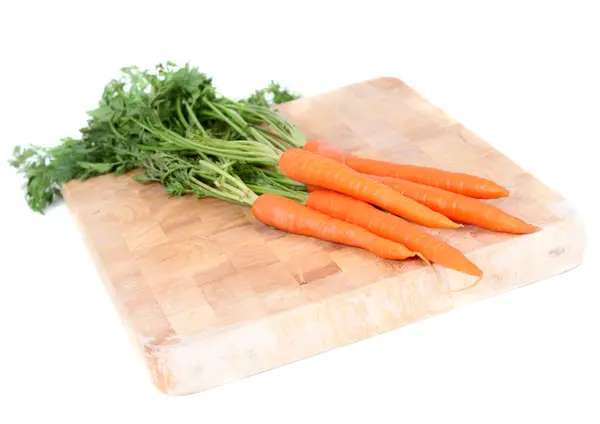 stock image Carrots on wooden board