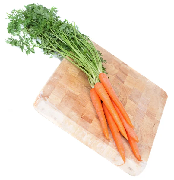 Carrots on wooden board — Stok fotoğraf