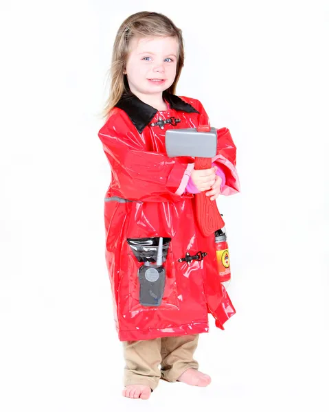 Peuter meisje in brandweerman kostuum — Stockfoto