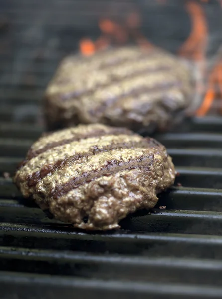 stock image Hamburgers sizzling on the grill