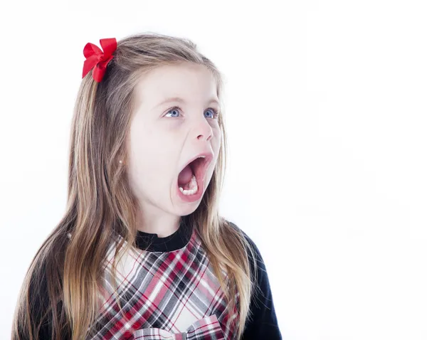 Young girl isolated on white with her mouth open looking to side — Stock Photo, Image