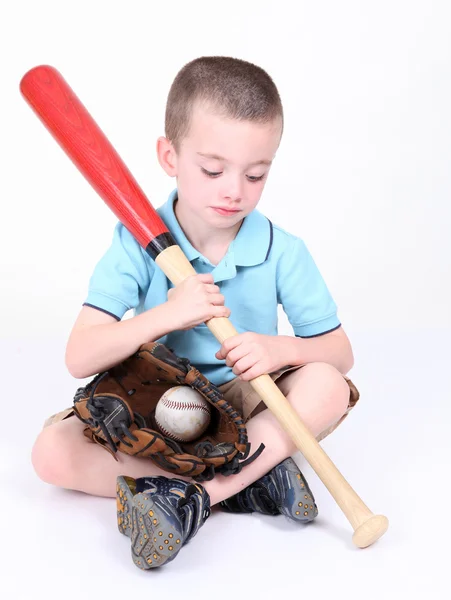 stock image Preschool boy looking down at bat