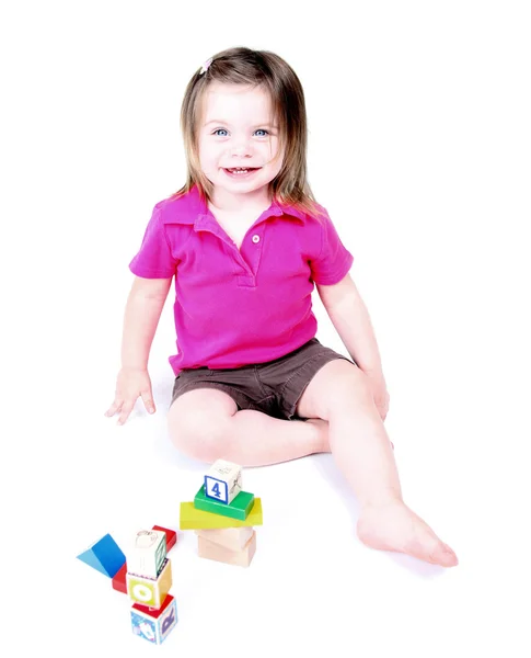 Toddler girl playing with childrens blocks — Stock Photo, Image