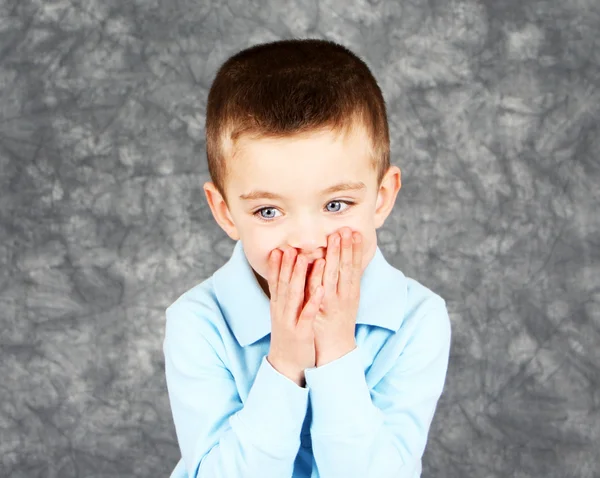 Young boy hiding face in hands — Stock Photo, Image