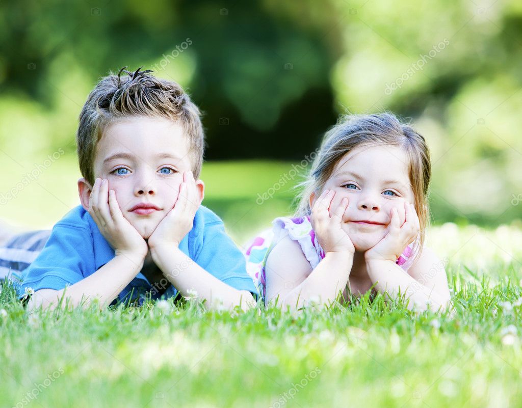 Siblings laying in the grass — Stock Photo © ericro #8651136