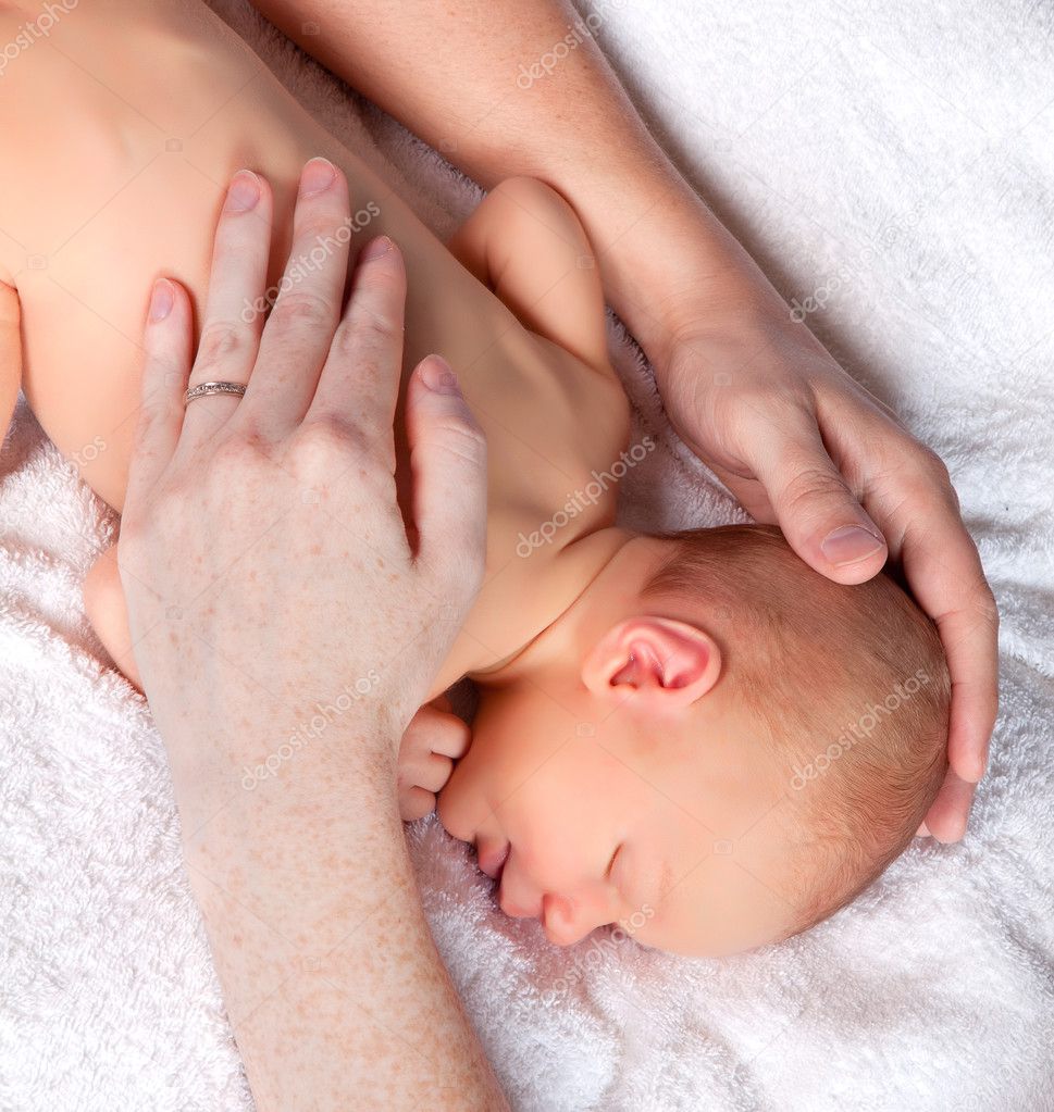 Hands protecting a baby