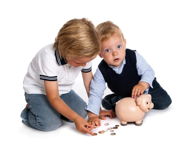Brothers filling their piggy bank Stock Image