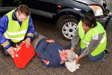 Paramedics with injured man clipart