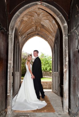 Wedding couple in church entrance clipart