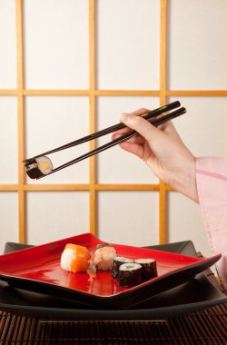 Serving sushi with chopsticks clipart