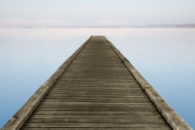 Zen jetty on foggy lake clipart