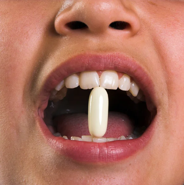 Pill in mouth — Stock Photo, Image