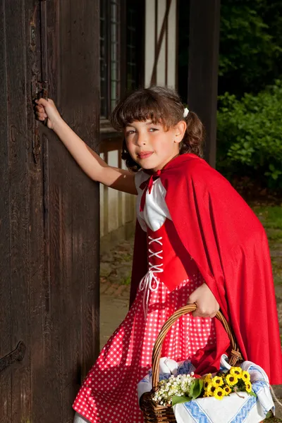 Little red riding hood knocking on door — Stock Photo, Image