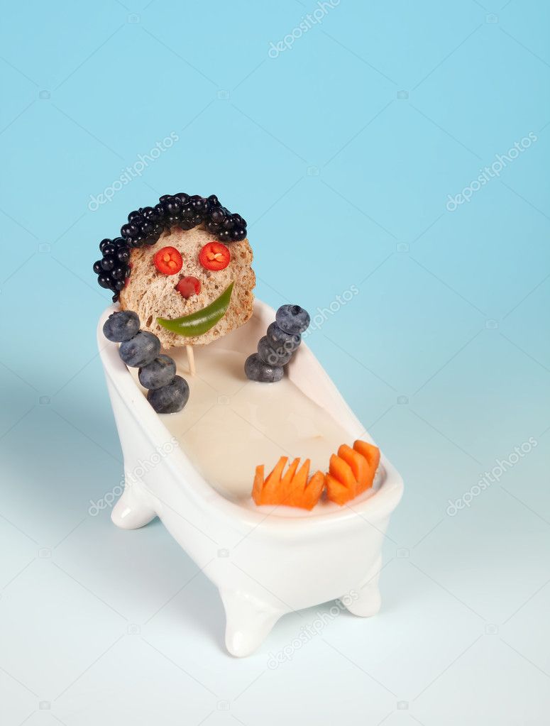 Funny food face taking a bath in milk