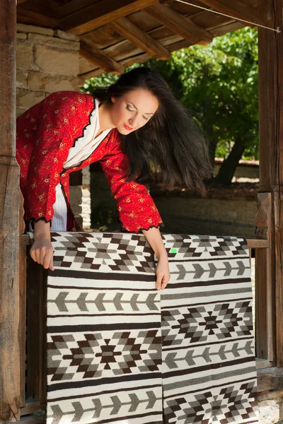 Bulgarian woman with carpets — Stock Photo, Image