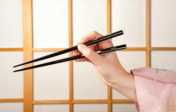 Hand with chopsticks — Stock Photo, Image