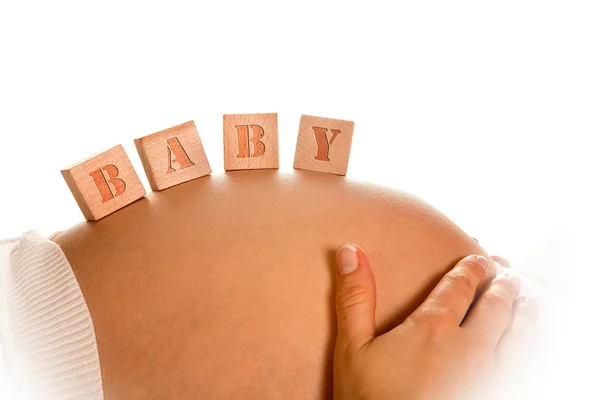 Blocks on pregnant belly — Stock Photo, Image