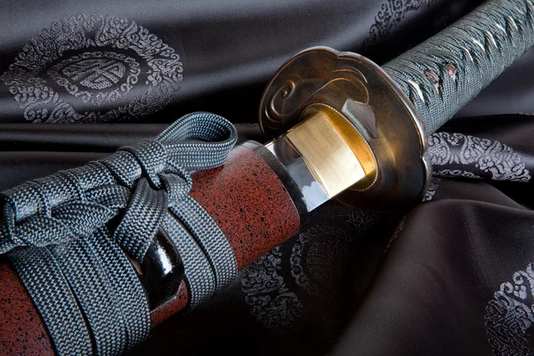 Japanese sword on silk — Stock Photo, Image