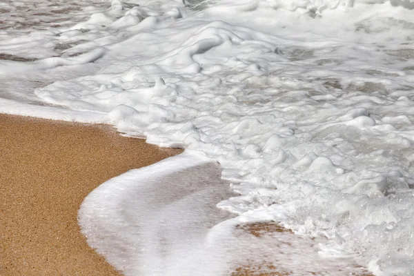 stock image Waves and foam on beach