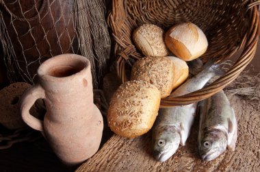 Wine jug with bread and fish clipart