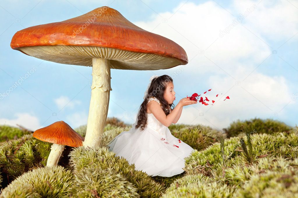 Fairy girl blowing rose petals