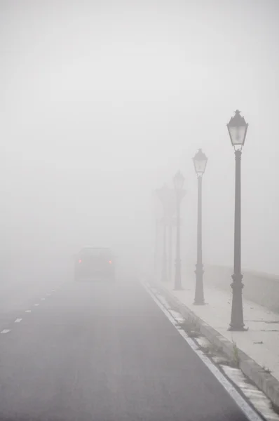 stock image Car driving vanish into the fog