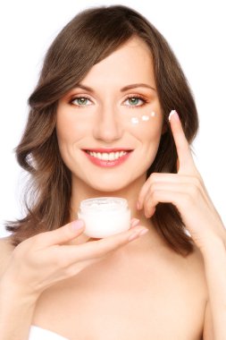 Woman applying cream clipart