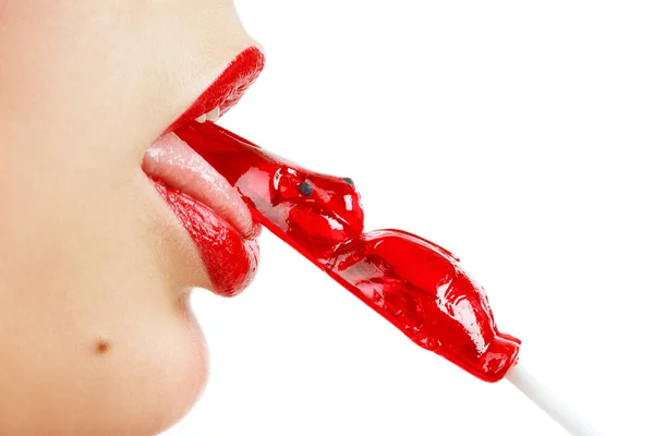 Close-up shot of womans mouth with bright red lips with lollipop — Stock Photo, Image