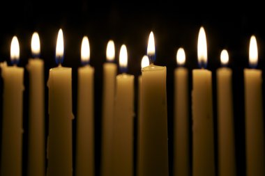 Several Candles on Black Background clipart