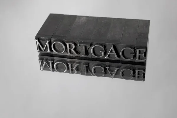 Mortgage spelled with Metal Type Reflection — Stock Photo, Image