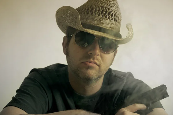 Człowiek w kowbojski kapelusz gospodarstwa pistolet — Zdjęcie stockowe