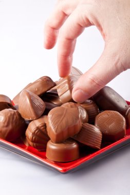 Hand taking chocolate clipart