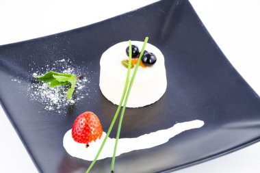 Nouvelle Cuisine Vanilla mousse dessert with cranberries on top clipart