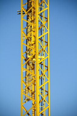 Metal tower of yellow crane in a industrial area clipart