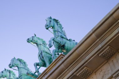 Brass horses over neoclassical ceiling clipart
