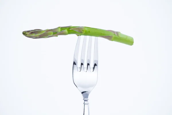Diet, asparagus bite in a fork — Stock Photo, Image