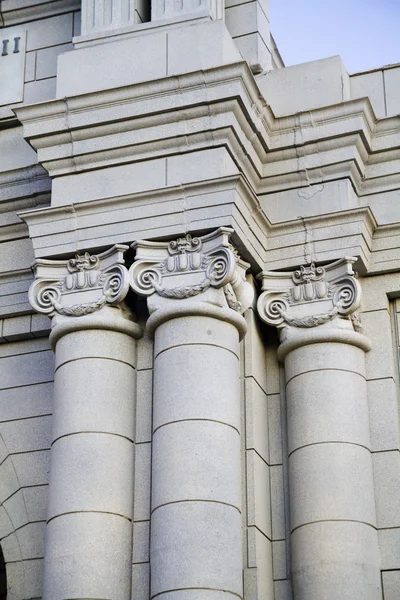 stock image Classical style columns in ionic order on exterior of modern building.
