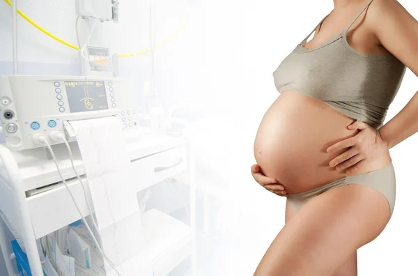 Pregnant in a hospital, white corridor — Stock Photo, Image