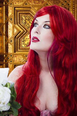 The beautiful young woman red haired in mysterious medieval room clipart