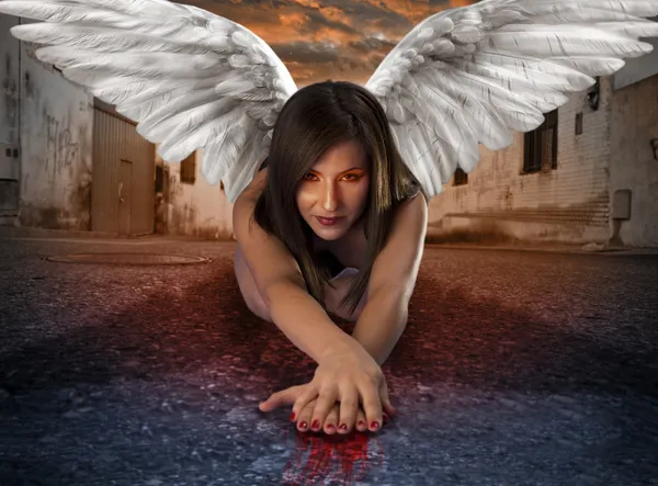 Apocalyptic female angel lying in the street with bloody hands — Stock Photo, Image