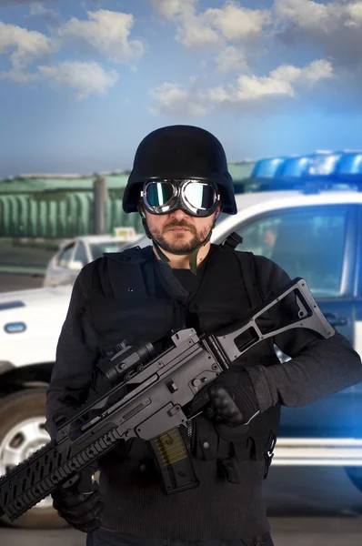 stock image Armed man in protective cask with machine gun. Police