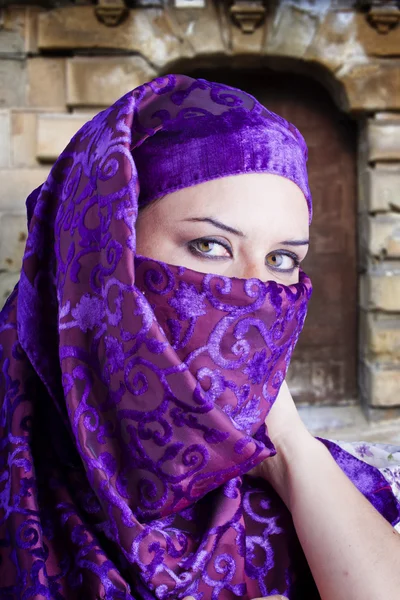 Женщина, одетая в костюм сахарауи, старый фон ворот — стоковое фото