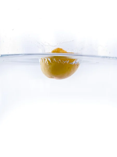Fruits falling into the water — Stock Photo, Image